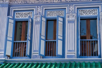 Canvas Print - Exterior view of a building with colorful door shutters in daylight