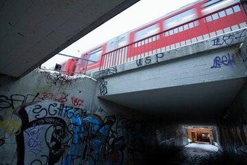 Poster - Tunnel with graffiti walls under a fast-moving train at Diebsteich station in Hamburg, Germany