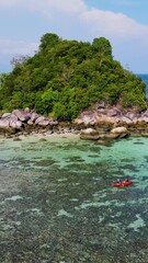 Wall Mural - people kayaking in the ocean of Koh Lipe Thailand, a couple of men and women in a kayak at a coral reef in Koh Lipe ocean. 