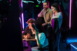 © Drobot Dean - Group of people watching their friend playing video game in cybersport club