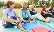© DisobeyArt - Senior people talking and hugging each others after yoga class outdoor at city park - Elderly lifestyle and multiracial concept - Main focus on left woman face