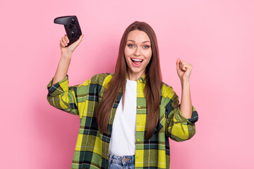 Wall Mural - Photo of young funny girl raise fists up hooray addicted professional cyber gamer hold joystick celebrate victory isolated on pink color background