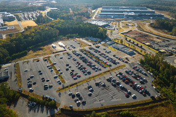 Canvas Print - Aerial view of many employee cars parked on parking lot in front of industrial factory building