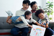 Male gay couple show their kid's family drawing, gay couple having fun with kids at home, LGBTQ family concept