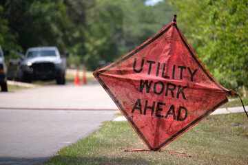 Wall Mural - Road work ahead sign on street site as warning to cars about construction and utility works