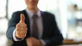 Fototapeta  - Manager businessman showing gesture thumb up at work in office closeup. Victory and successful strategy in business concept