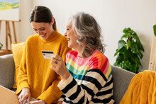 Happy Daughter And Mother Shopping Online With Credit Card At Home