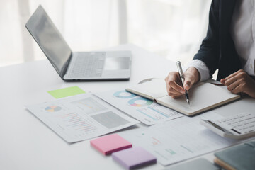 Wall Mural - Businessman working in a private office, she is reviewing the company's financial documents sent from the finance department before he takes it to a meeting with a business partner. Financial concept.