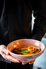 chef hand hold bowl with Japanese clam seafood soup