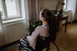 © Halfpoint - Unhappy teenage girl sitting on a wheelchair and looking out of the window.