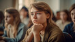 © Giordano Aita - Teenage girl in the foreground in a high school classroom, in the background her classmates listen attentively to the lesson