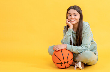 photo of teen basketball girl with ball, copy space. teen basketball girl isolated on yellow.