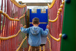 © ADDICTIVE STOCK - Little kid walking on rope bridge