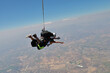 © Sky Antonio - Skydiving. Tandem is falling above the summer land.