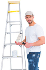 Wall Mural - Portrait of painter holding paint roller by step ladder