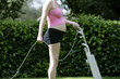 © Designpics - Pregnant Woman Mowing Lawn with Vacuum Cleaner