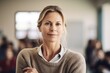 © Robert MEYNER - Portrait of mature businesswoman with arms crossed looking at camera in office