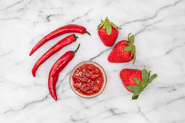 Close-up of strawberries and homemade jam with red peppers