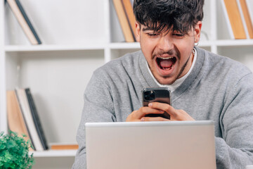 Wall Mural - young man in with mobile phone and laptop