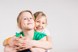 © Designpics - Portrait of Girl Hugging her Sister in Studio