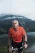 © Designpics - Mature Man Riding Mountain Bike by Vilsalpsee, Tannheim Valley, Tyrol, Austria