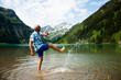© Designpics - Mature man standing in lake, kicking water, Lake Vilsalpsee, Tannheim Valley, Austria