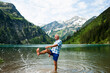 © Designpics - Mature man standing in lake, kicking water, Lake Vilsalpsee, Tannheim Valley, Austria
