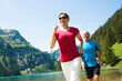 © Designpics - Mature man and woman power walking, Lake Vilsalpsee, Tannheim Valley, Austria