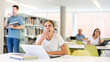 © JackF - Female student yawns out of boredom in the public library