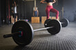 © Wavebreak Media - Barbells on floor in health club with people in background, copy space