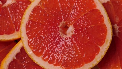 Wall Mural - Grapefruit slices rotating. Closeup fruit background. Nobody