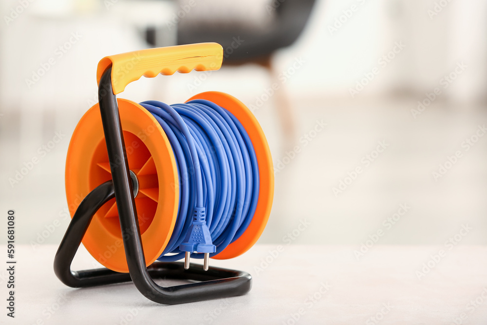 Extension electric cable reel on table