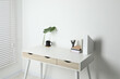 © New Africa - Comfortable workplace with white desk near wall indoors