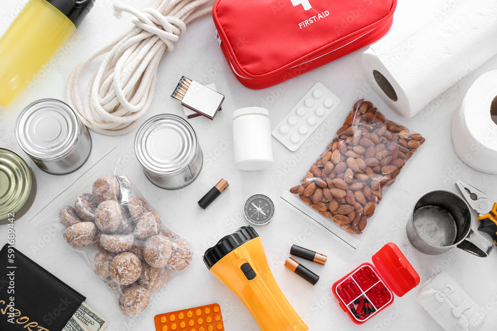 Necessities for emergency bag on white table