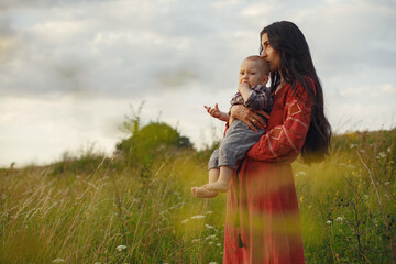 Wall Mural - Mother with little son playing in a summer field