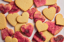 Stamped Heart Cut-Out Cookies With Pink Sugar On A Pink Marble Background