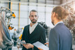 © Quality Stock Arts - Businessman working in machinery factory robot assembly plant team working together