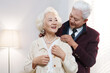© View Stock - The old man helps his wife wear a pearl necklace