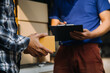 © ARMMY PICCA - Startup SME small business entrepreneur of freelance Asian woman wearing apron using laptop and box to receive and review orders online to prepare to pack sell to customers, online sme business ideas.