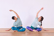 © Albert - Two girls doing yoga, with their hands apart, making the Chin mudra