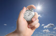 © New Africa - Man holding timer against beautiful sky, closeup. Space for text