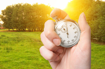 Sticker - Woman holding timer on lawn with trees, closeup. Space for text