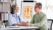 © Katcha - Female doctor holding hands to encourage senior patient and expl