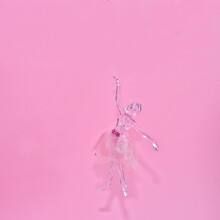Crystal Glass Ballerina Figure Isolated On A Pink Background