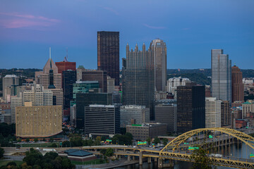 Wall Mural - Cityscape of Pittsburgh and Evening Light. Fort Pitt Bridge. Blurry Ferry Cruise in Background Because of Long Exposure. Selective focus.