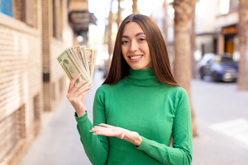 Poster - smiling cheerfully, feeling happy and showing a concept. dollar banknotes concept