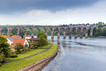 A Train Crosses The Royal Border Bridge Over The River Tweed At Berwick Upon Tweed In Northumberland, England.