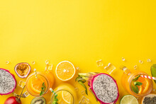 A Fruity Oasis. Top Flat Lay View Photo Of Colorful And Tasty Fruit Juice Or Cocktail In Glass Jar, Dragon-fruit, Kiwi, Orange, Lime, Passion Fruit On Vibrant Yellow Backdrop With Empty Space