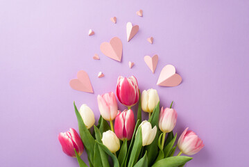 Wall Mural - Mother's Day surprise concept. Top view flat lay of pretty tulip flowers, paper hearts on a soft pastel purple background with space for text or advert