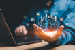 © NongAsimo - Customer network relationship management concept on virtual screens, Businessman use laptops and hold global structure customer network in hand, Data management and business work development